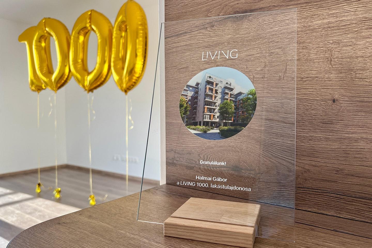 An award for the 1000th home owner next to 1000 balloons